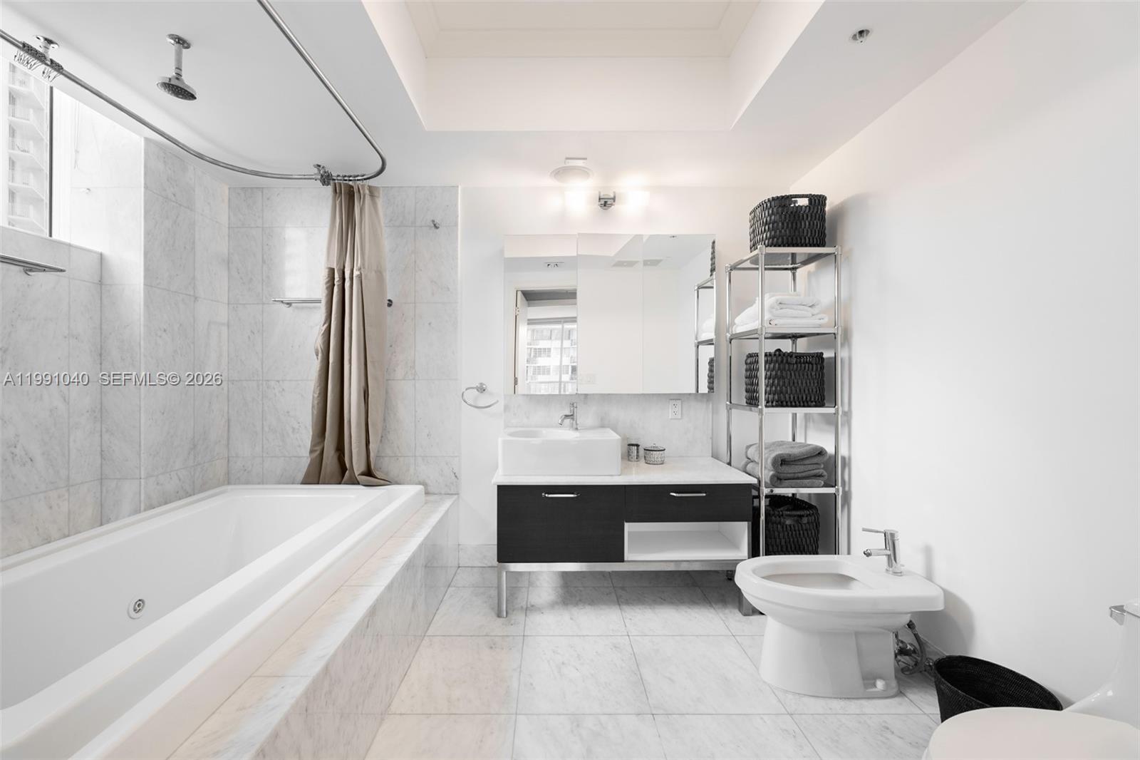 218 Southeast 14th Street, Unit 1007 Miami, FL 33131 - Photo 13 of 32 a bathroom with a bathtub shower sink mirror and toilet