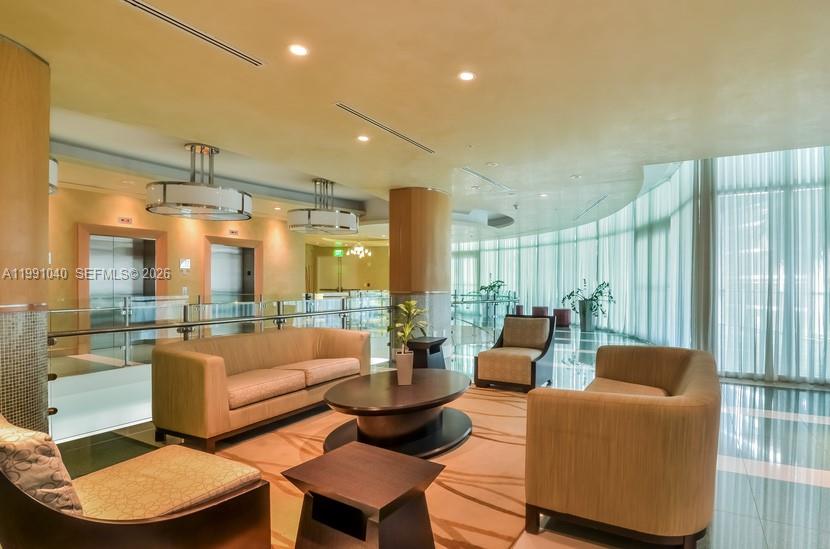 218 Southeast 14th Street, Unit 1007 Miami, FL 33131 - Photo 16 of 32 a living room with furniture and a large window