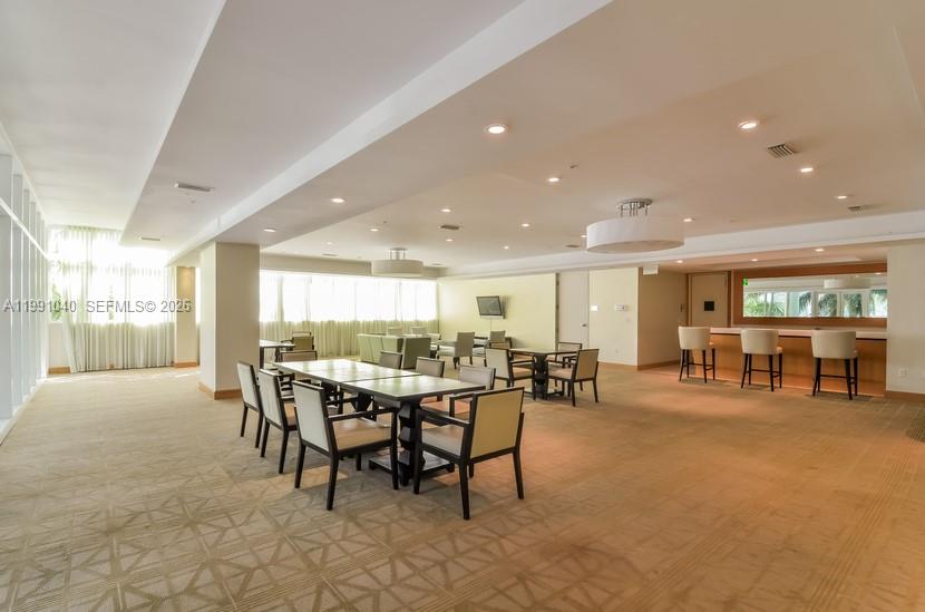 218 Southeast 14th Street, Unit 1007 Miami, FL 33131 - Photo 17 of 32 a view of a dining area with furniture and window in the room