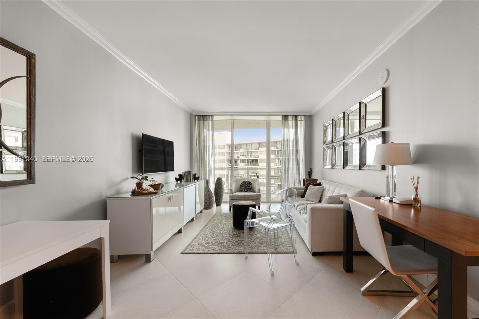 218 Southeast 14th Street, Unit 1007 Miami, FL 33131 - Photo 2 of 32 a living room with furniture and a flat screen tv