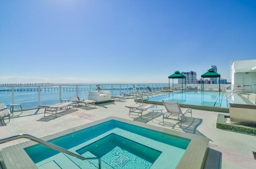 218 Southeast 14th Street, Unit 1007 Miami, FL 33131 - Photo 22 of 32 a view of a patio with furniture and a table and chairs