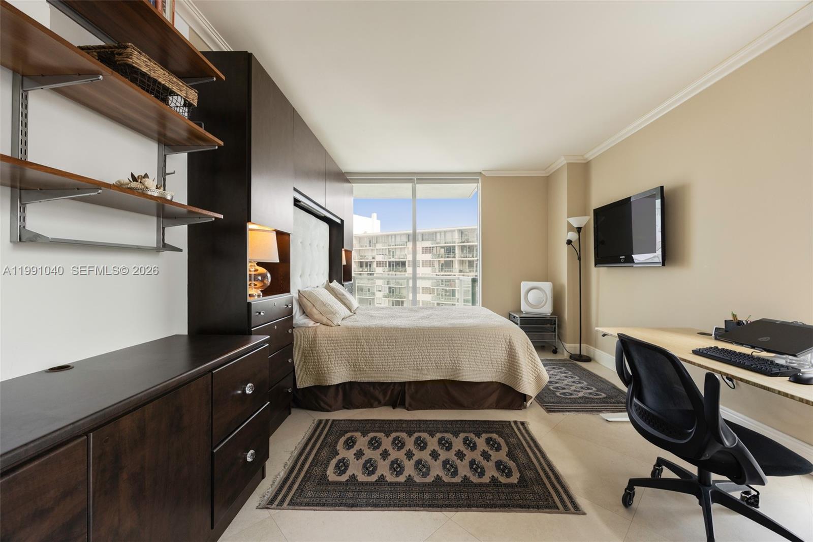 218 Southeast 14th Street, Unit 1007 Miami, FL 33131 - Photo 4 of 32 a bedroom with a bed and a flat screen tv