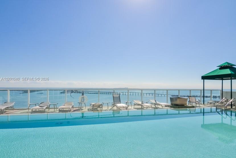 218 Southeast 14th Street, Unit 1007 Miami, FL 33131 - Photo 6 of 32 a living room with furniture and a floor to ceiling window