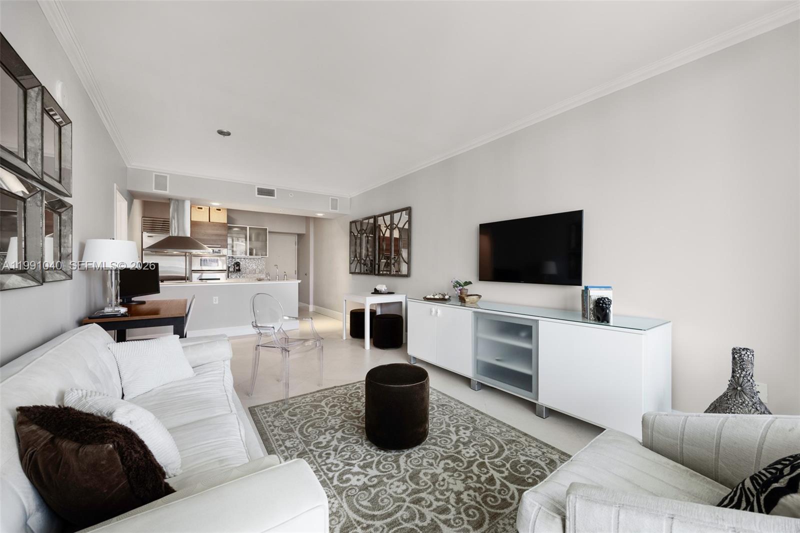 218 Southeast 14th Street, Unit 1007 Miami, FL 33131 - Photo 10 of 32 a living room with furniture and a flat screen tv