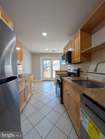 a kitchen with a sink appliances and cabinets