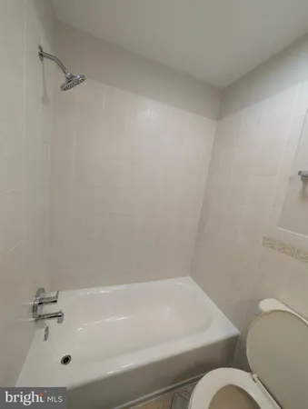 a bathroom with a bathtub and toilet