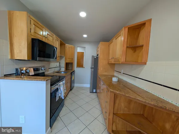 a kitchen with granite countertop a sink and a stove top oven