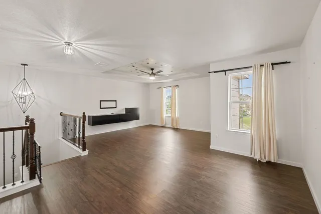 an entryway wooden floor and a chandelier in a room
