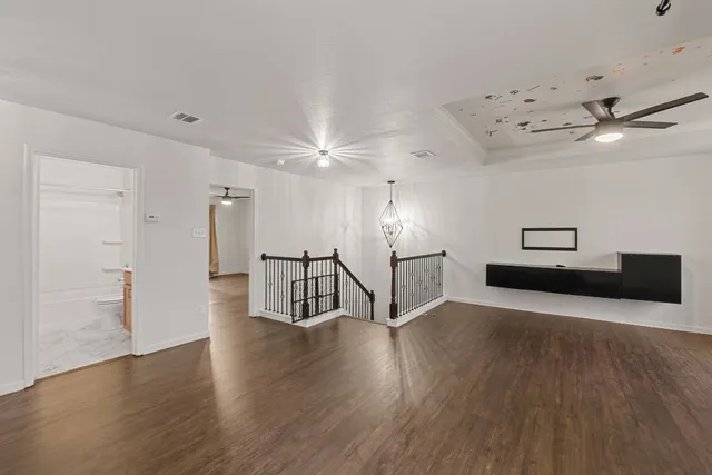 a kitchen with granite countertop a sink cabinets wooden floor and stainless steel appliances