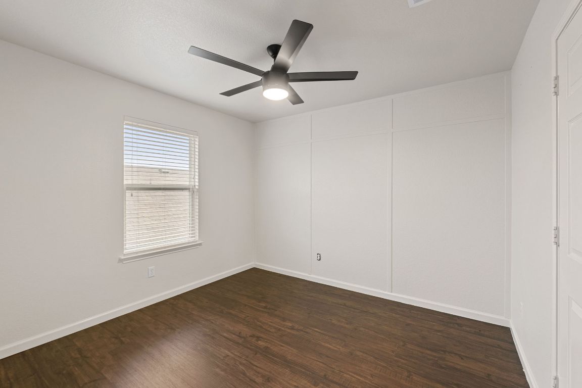 240 Nectar Drive Buda, TX 78610 - Photo 23 of 37 an empty room with wooden floor fan and windows