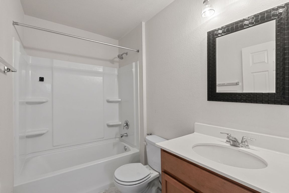 240 Nectar Drive Buda, TX 78610 - Photo 29 of 37 a bathroom with a sink a toilet and shower