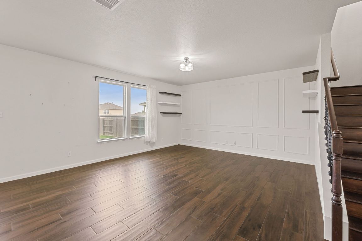 240 Nectar Drive Buda, TX 78610 - Photo 5 of 37 wooden floor in an empty room with a window