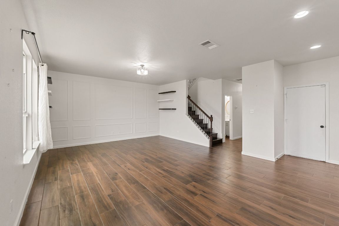 240 Nectar Drive Buda, TX 78610 - Photo 6 of 37 a view of a room with wooden floor and stairs