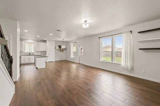a view of kitchen dining table chairs microwave and cabinets