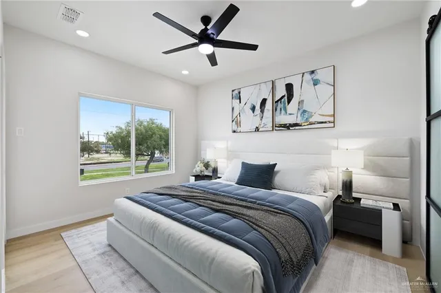 a bedroom with a bed and a painting on the wall