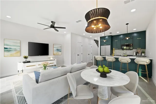 a living room with furniture a rug and a flat screen tv