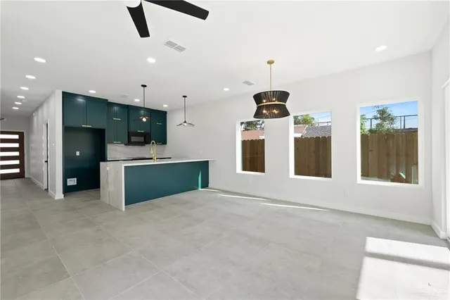 a large kitchen with stainless steel appliances kitchen island a large island in the center