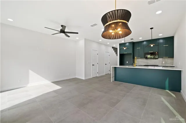 a kitchen with a sink and a chandelier
