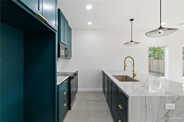 a kitchen with stainless steel appliances granite countertop a sink and dishwasher