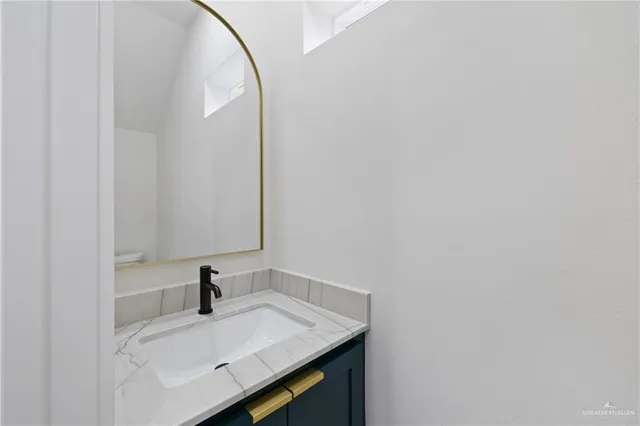 a bathroom with a sink and vanity
