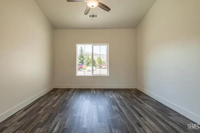 wooden floor in an empty room with a window