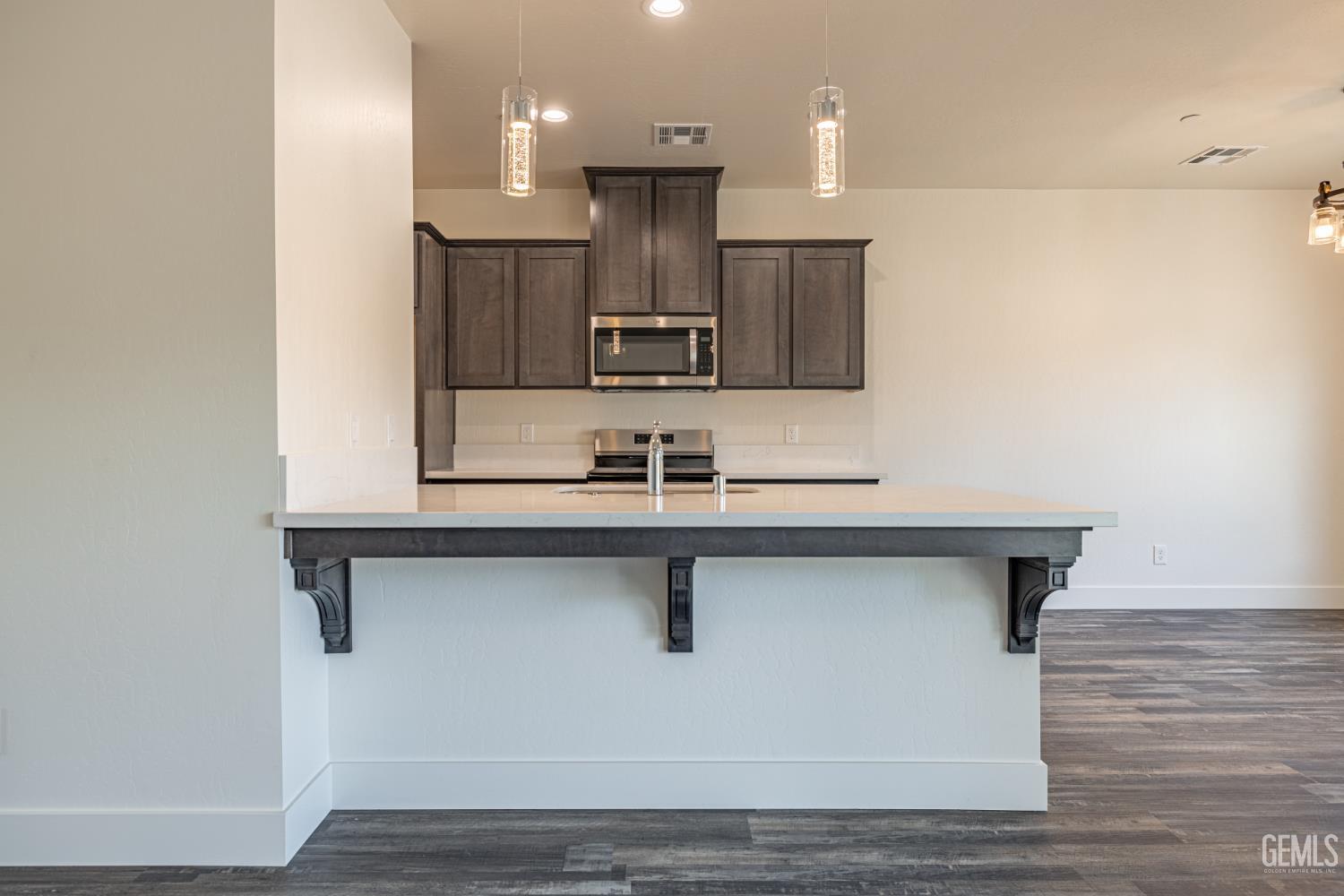 Undisclosed Address Tehachapi, CA 93561 - Photo 7 of 20 a kitchen with kitchen island a sink stainless steel appliances and cabinets
