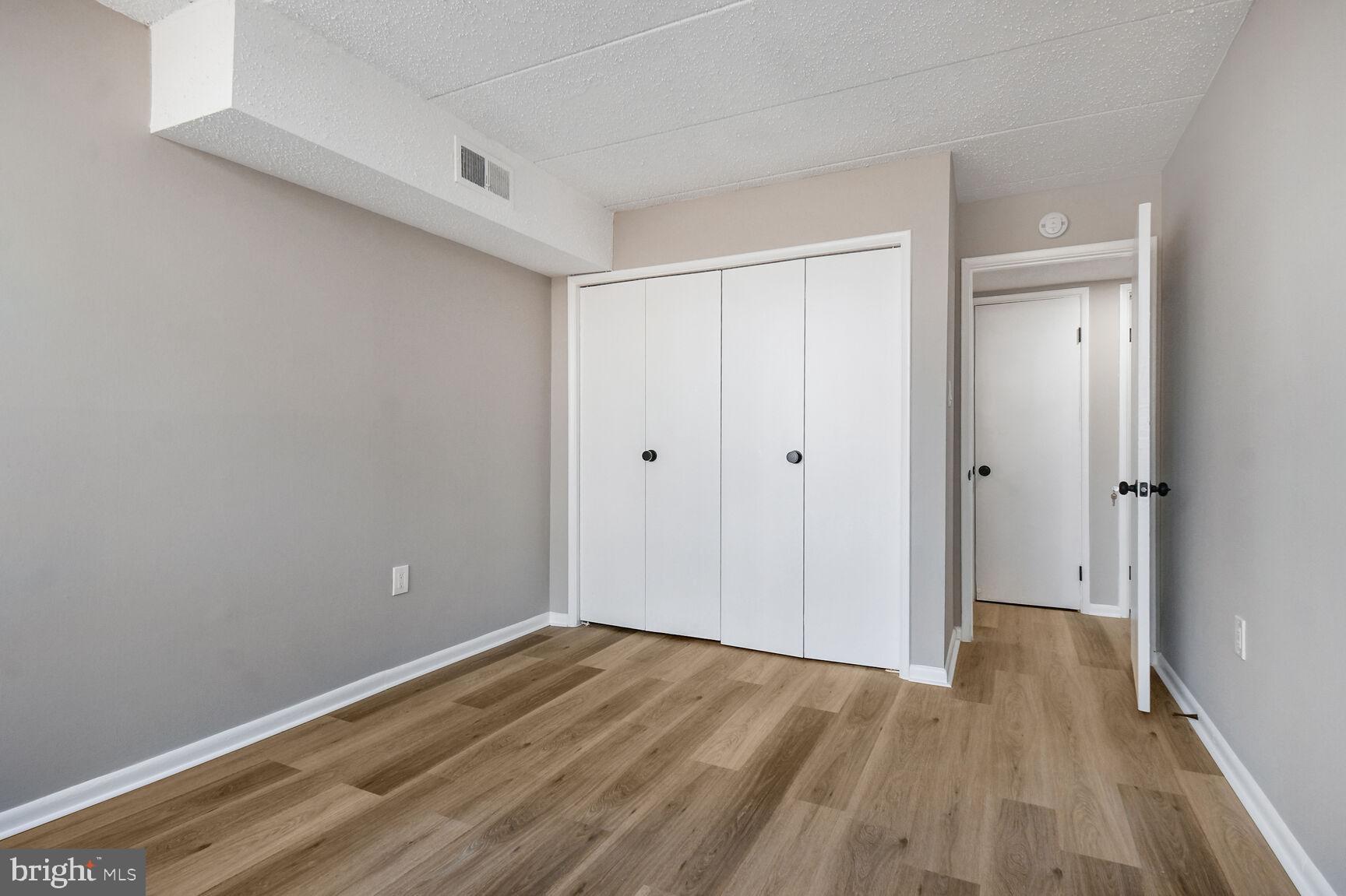 1804 Metzerott Road, Unit 106 Silver Spring, MD 20903 - Photo 12 of 15 a view of an empty room with wooden floor