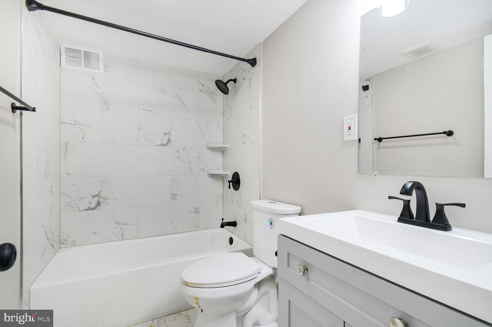 1804 Metzerott Road, Unit 106 Silver Spring, MD 20903 - Photo 15 of 15 a bathroom with a sink a toilet and a bathtub
