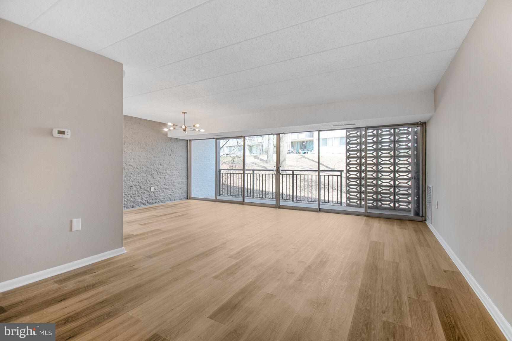 1804 Metzerott Road, Unit 106 Silver Spring, MD 20903 - Photo 2 of 15 wooden floor in an empty room with a window