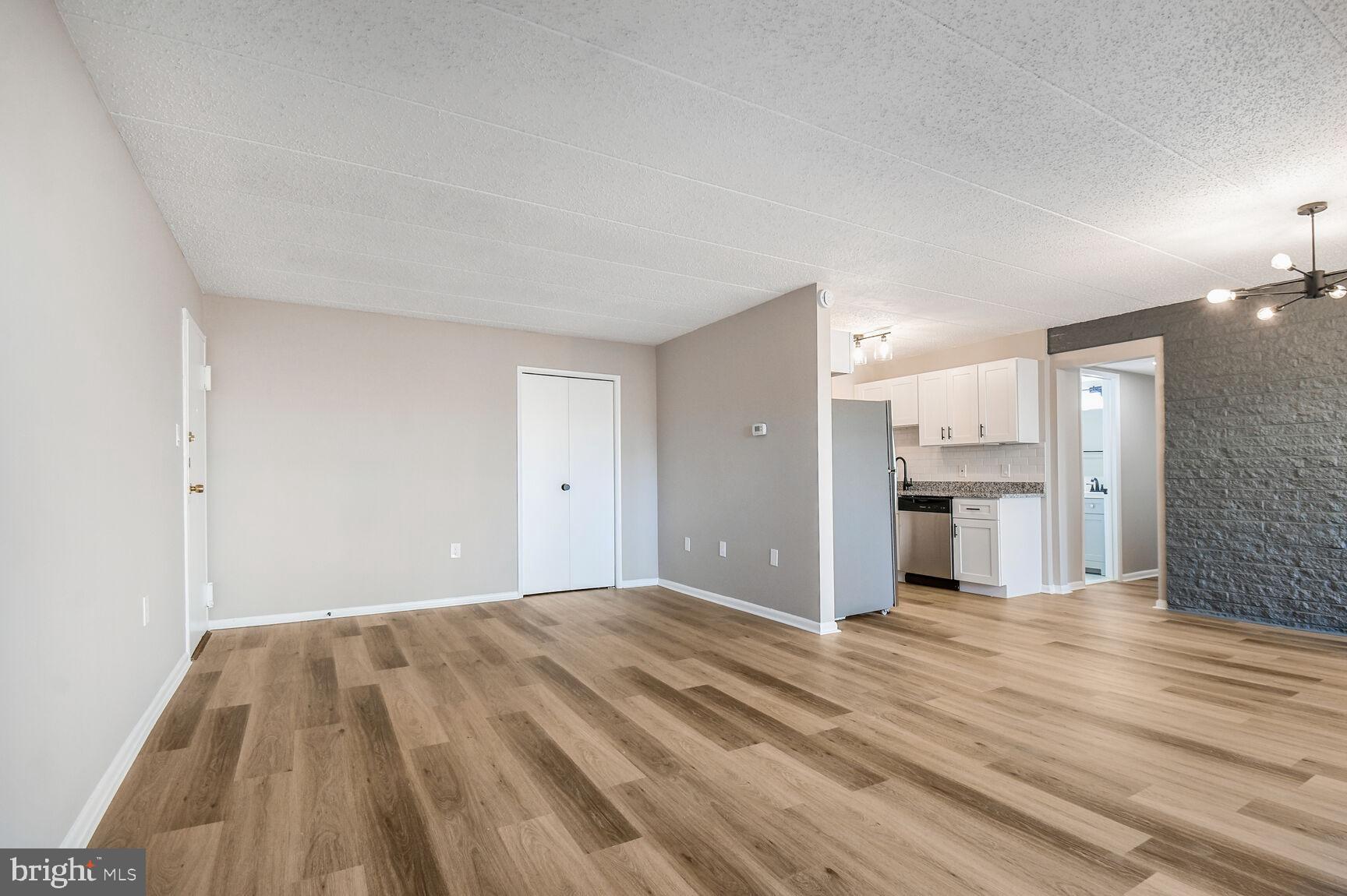 1804 Metzerott Road, Unit 106 Silver Spring, MD 20903 - Photo 5 of 15 a view of a kitchen with a sink and a refrigerator