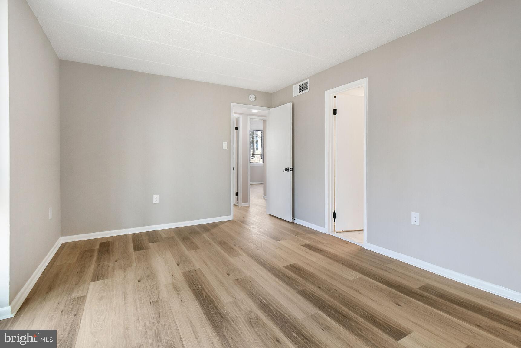 1804 Metzerott Road, Unit 106 Silver Spring, MD 20903 - Photo 9 of 15 a view of an empty room and wooden floor