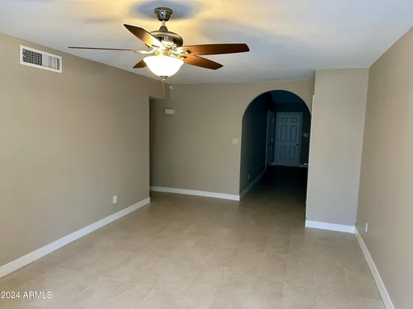 a view of an empty room with a ceiling fan