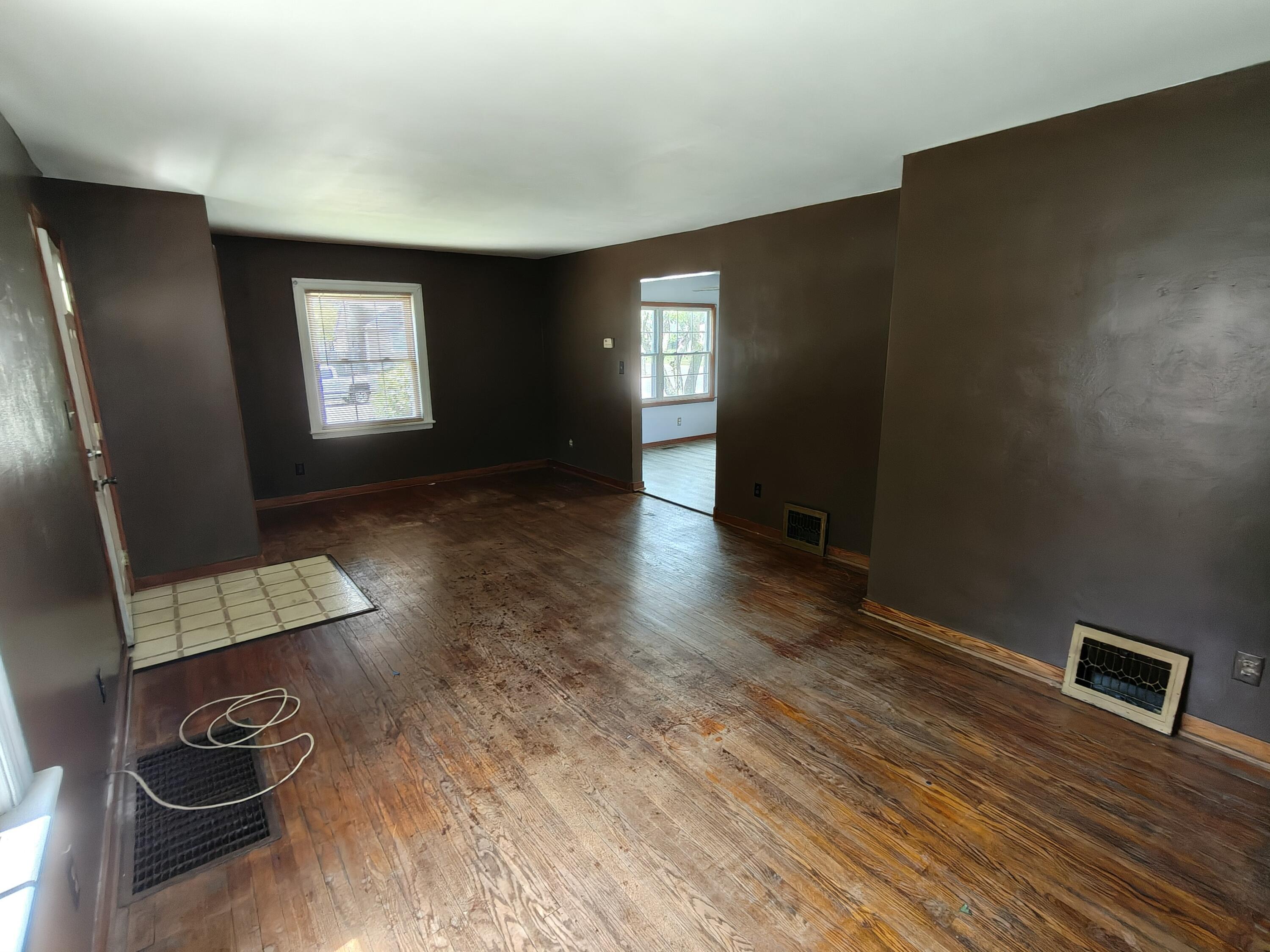 245 North Indiana Street Griffith, IN 46319 - Photo 6 of 30 a view of an empty room with wooden floor and a window