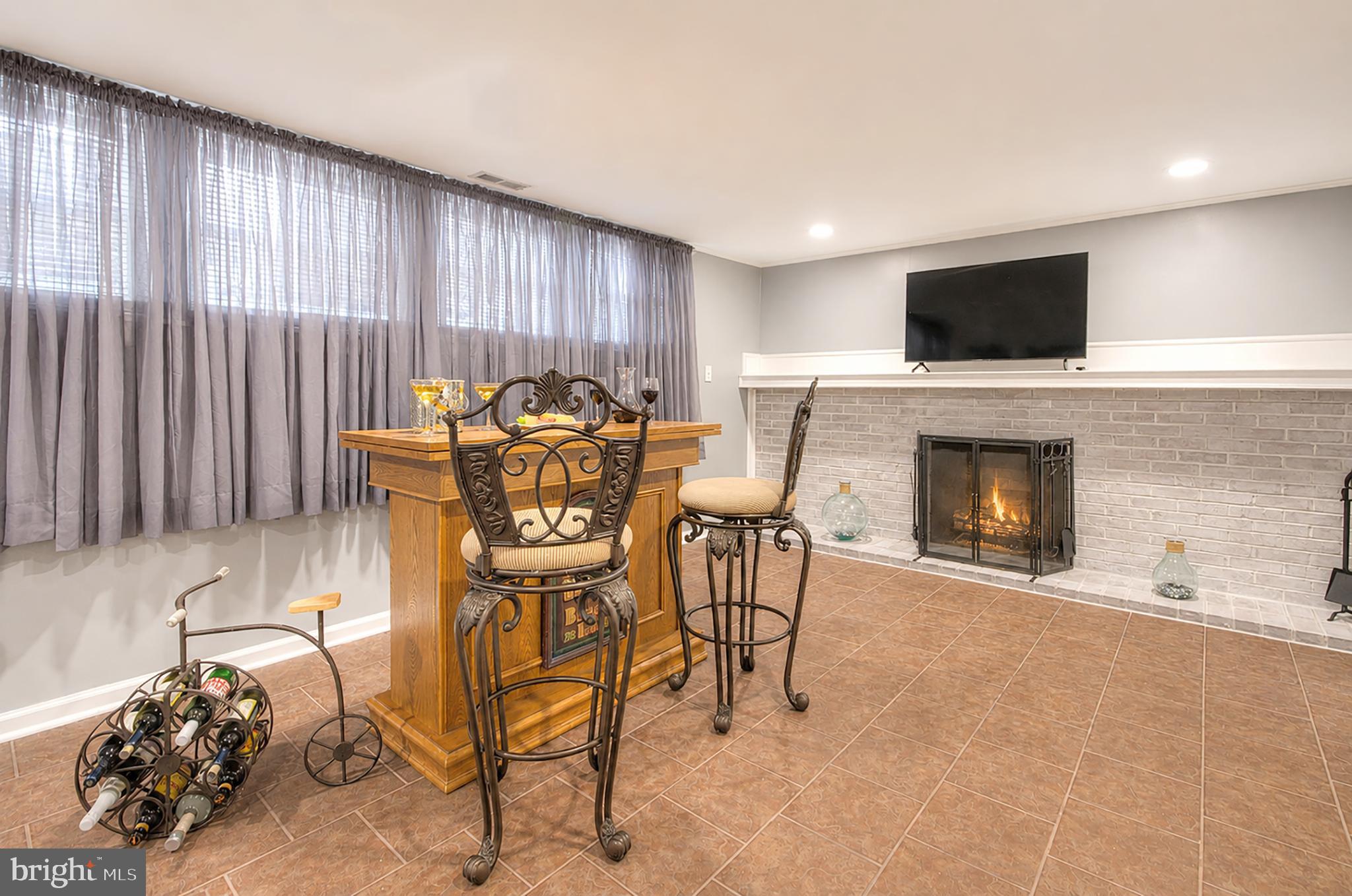 32 Bryant Road Turnersville, NJ 08012 - Photo 23 of 33 a living room with furniture a flat screen tv and a fireplace