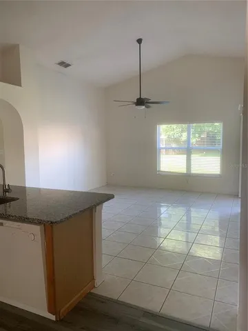 a view of a kitchen with furniture and a sink