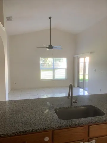 a kitchen with granite countertop a sink and a window