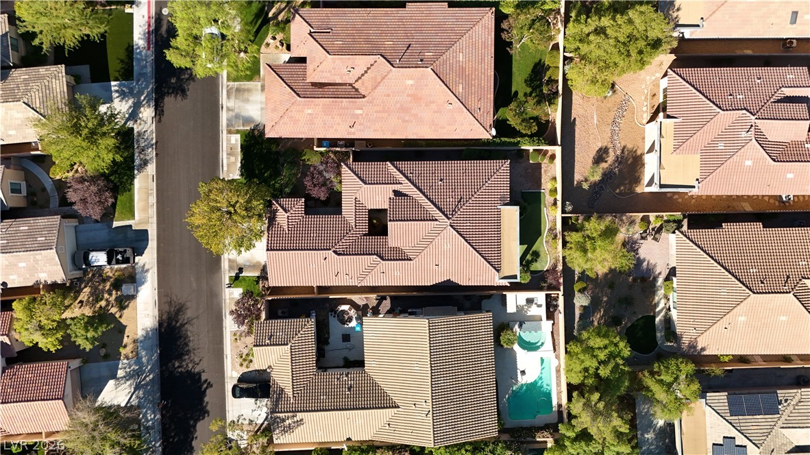 6 Mohansic Road Henderson, NV 89052 - Photo 35 of 38 An aerial perspective showcases the classic tile roofing and private pool of this suburban home.