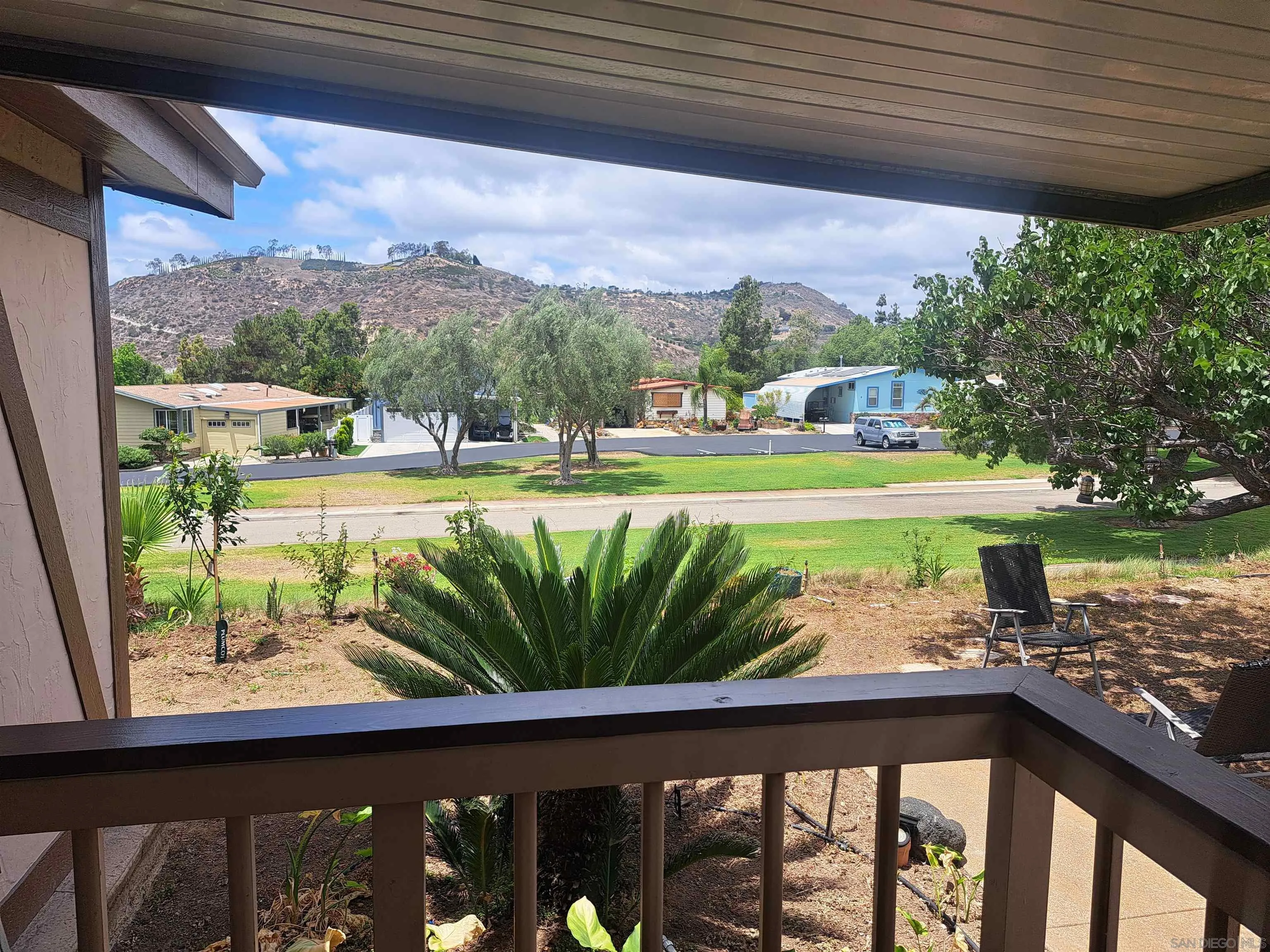 4650 Dulin Road, Unit 12 Fallbrook, CA 92003 - Photo 6 of 36 a view of a patio with lawn chairs next to a yard