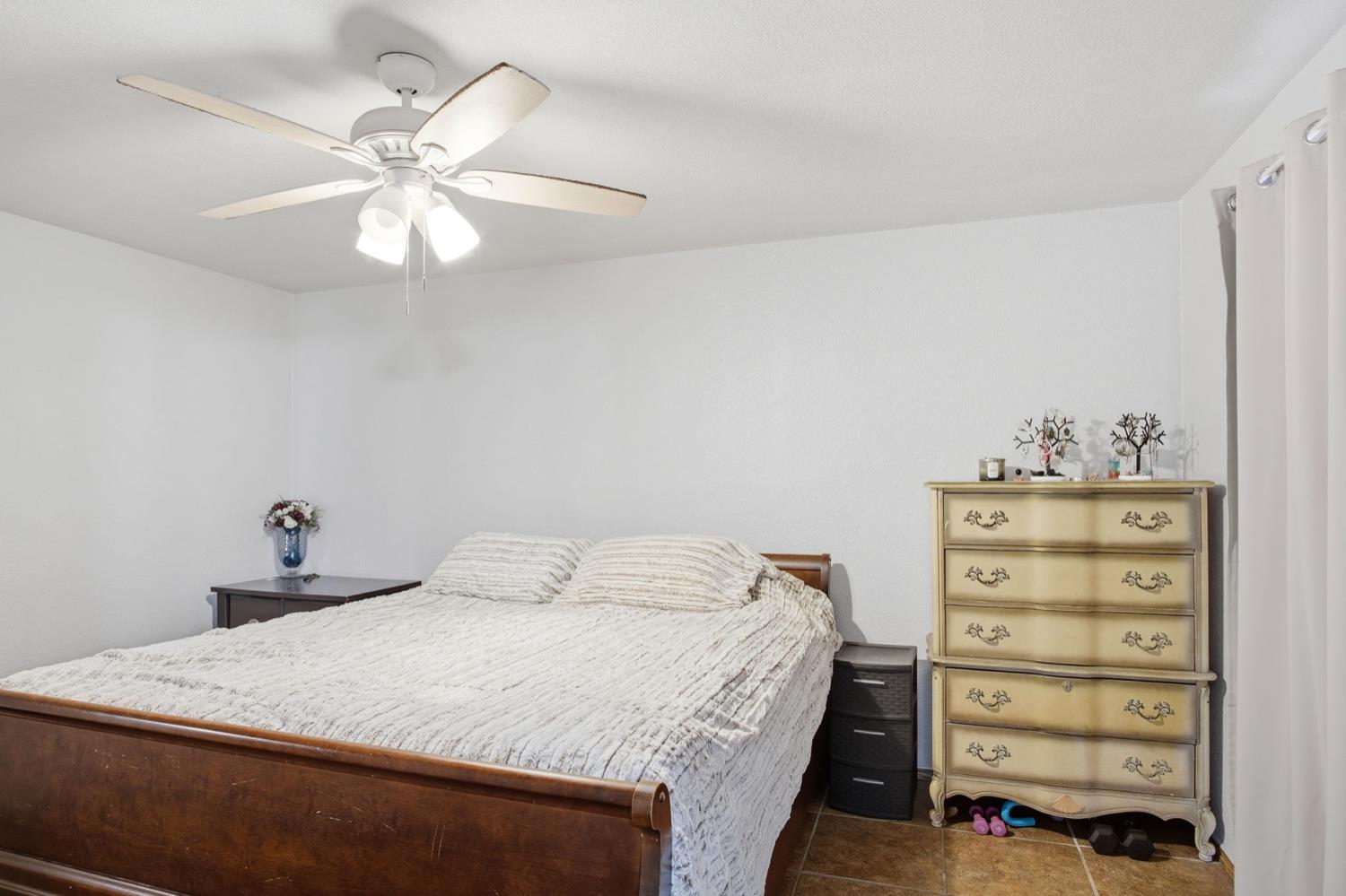 1429 Don Pedro Road Ceres, CA 95307 - Photo 16 of 21 a bedroom with a bed and a chandelier