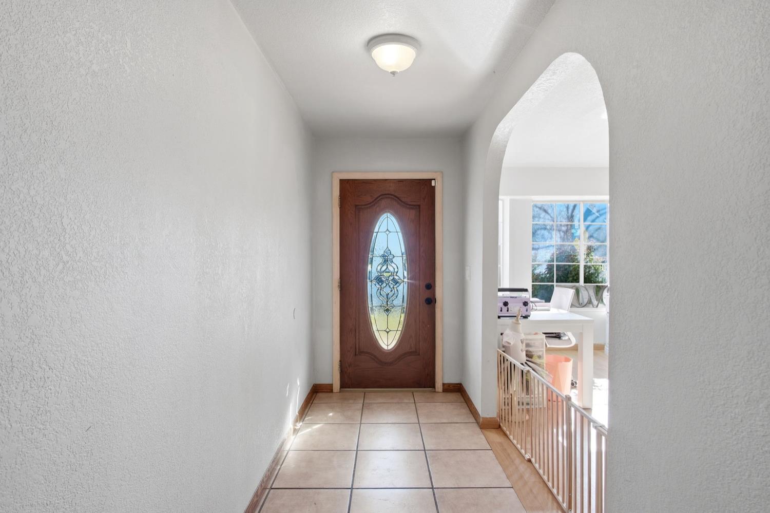 1429 Don Pedro Road Ceres, CA 95307 - Photo 5 of 21 a hallway with painting and a large window