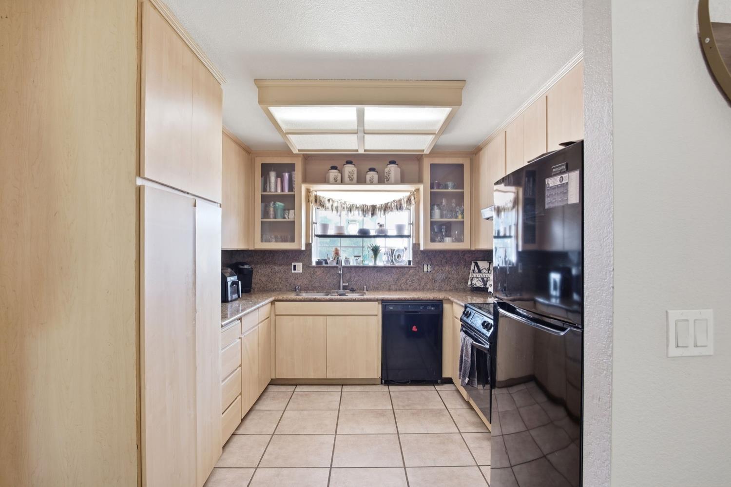 1429 Don Pedro Road Ceres, CA 95307 - Photo 8 of 21 a kitchen with a sink a counter top space stainless steel appliances and cabinets