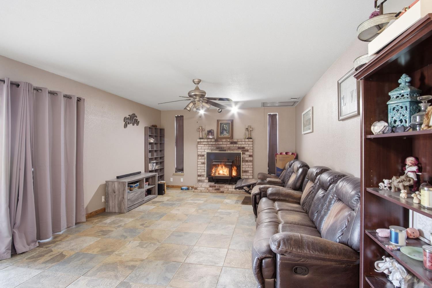 1429 Don Pedro Road Ceres, CA 95307 - Photo 10 of 21 a living room with furniture a fireplace and a chandelier