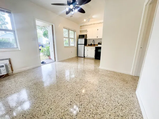 a view of a kitchen with wooden floor and a kitchen