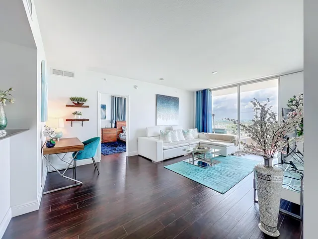 a living room with furniture and wooden floor