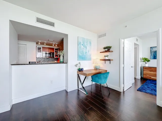 a view of a dining room with furniture and wooden floor