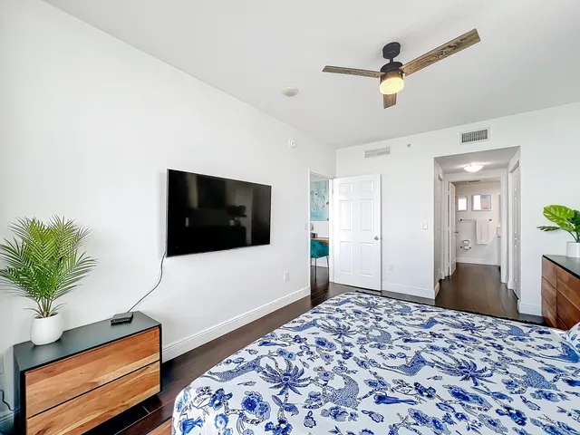 a bedroom with a bed and a television