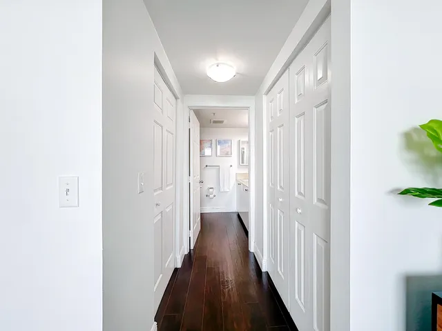 a view of a hallway with wooden floor