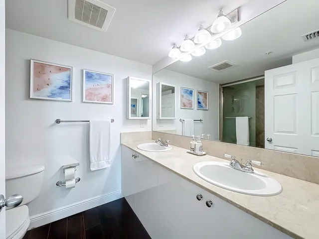 a bathroom with a sink double vanity and a mirror