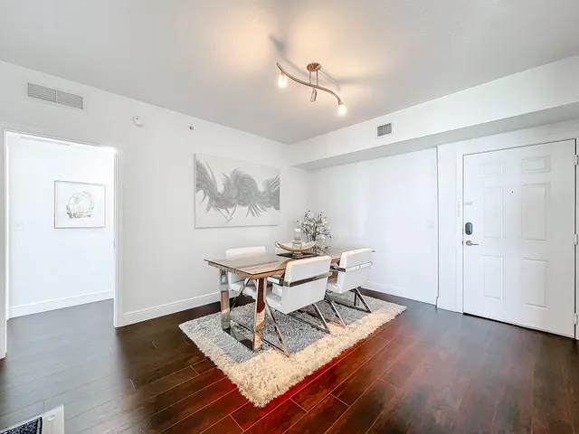 a view of a dining room with furniture wooden floor and a rug
