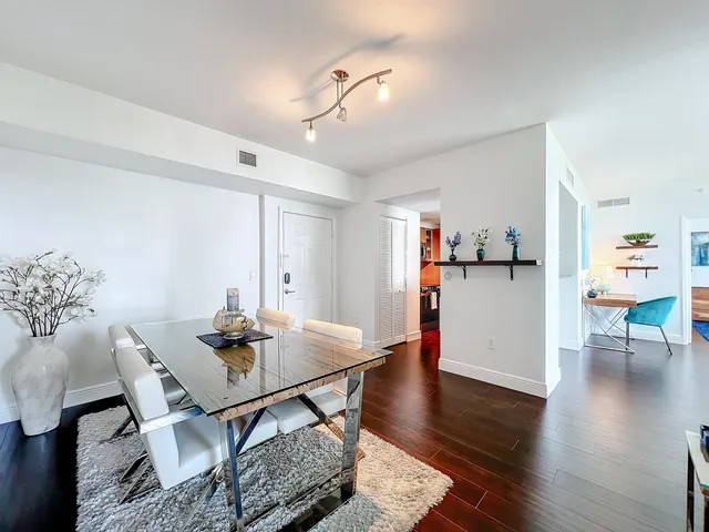 a view of a dining room with furniture and wooden floor